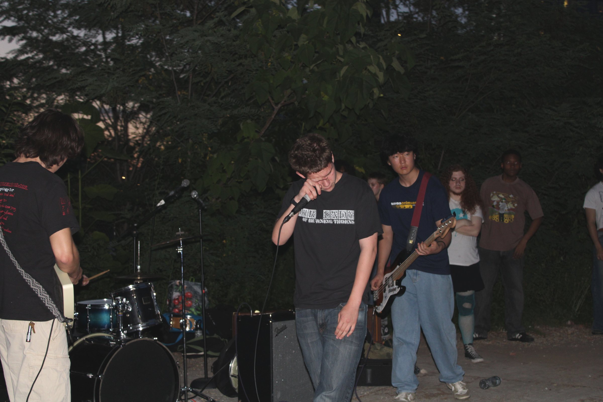This Is Forgiveness playing an outdoor show at dusk